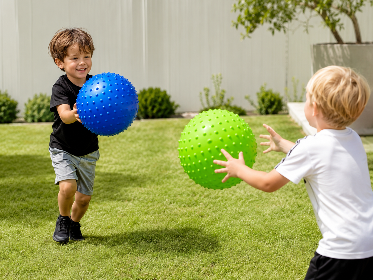 Children playing with large knobby sensory balls